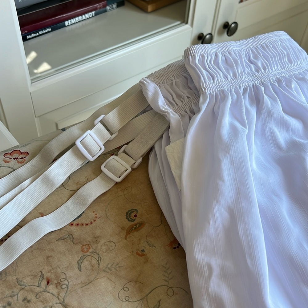 This is a king sized bed skirt with elastic bands that fit over your mattress.